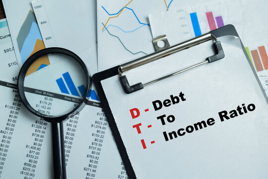 Concept of DTI - Debt To Income Ratio write on clipboard isolated on Wooden Table.