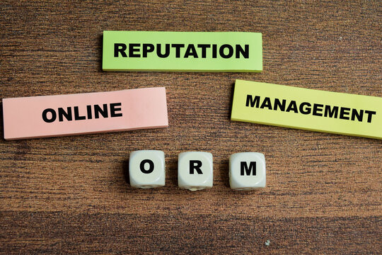 Concept of ORM - Online Reputation Management write on sticky notes isolated on Wooden Table.