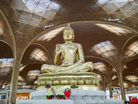 Phnom Penh, Cambodia - February 7, 2026: A large golden Buddha statue sits inside Techo International Airport departure lounge in Phnom Penh, Cambodia.