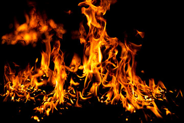 Fototapeta premium Flame glows above orange flames. Flame frames bright flames. Realistic flame with fire. Burning flame beside fire.