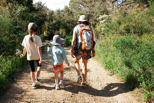 Grandmother and kids Walk Along Mediterranean landscape