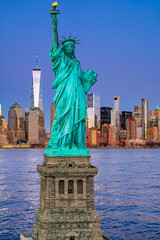 Fototapeta premium NYC view with Statue of Liberty. Evening with the Statue of Liberty. Manhattan skyscrapers with Statue of Liberty. New York skyscrapers near Liberty Statue. Voting in United States.