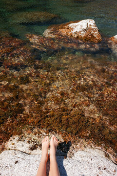 Feet and Mediterranean sea. Costa Brava, Girona, Spain