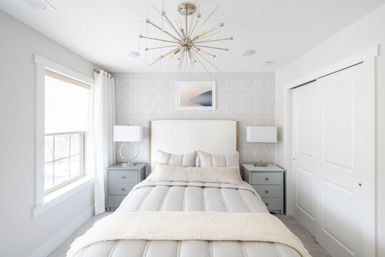Serene White Bedroom with Chevron Dresser, Round Mirror and Fluffy White Bedding