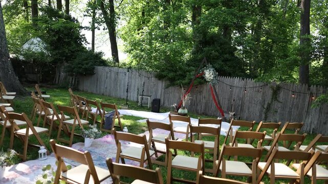 Outdoor wedding ceremony setup in backyard garden