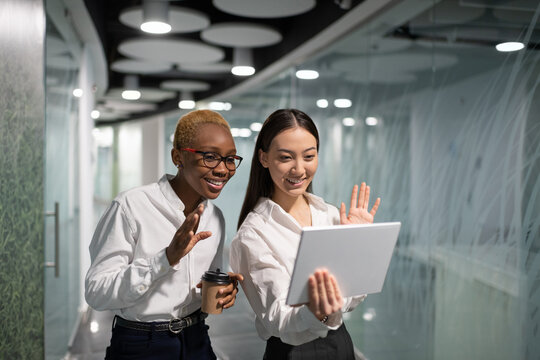 Happy multiethnic businesswomen making video call