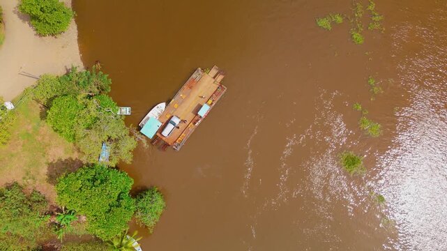 Aerial view of a river ferry with a car onboard