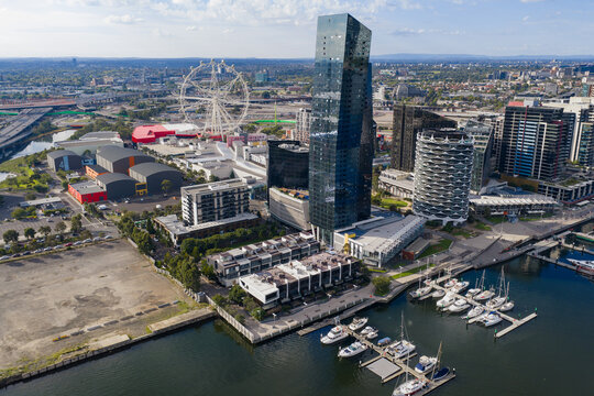 Boats moored along an inner city waterfront below tall skyscapers