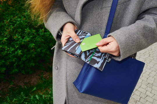 Woman takes the credit card out of her wallet