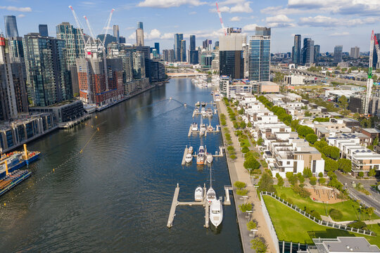 Boats and yachts moored along an inner city river waterfront precinct