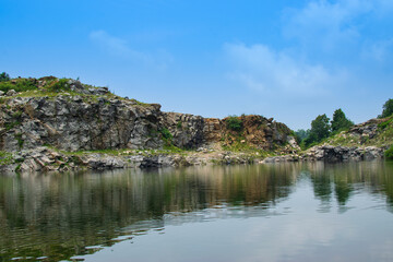 Fototapeta premium Tarpania Lake, Marble Lake, Blue Dam, Patal Dam or Durga Bera,a scenic lake in the Ajodhya Hills of Purulia, West Bengal, India. Deep blue water surrounded by sharp, white, marble-like rocky cliffs.