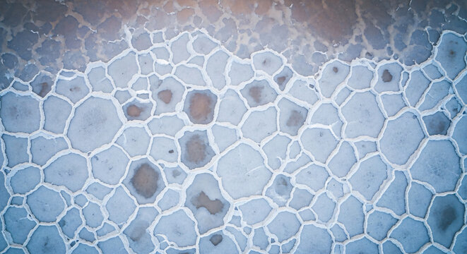Aerial View of Hexagonal Salt Crust Patterns on Flat Surface