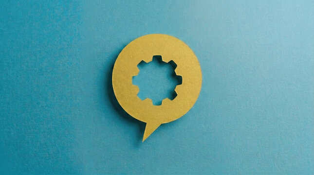 Yellow paper speech bubble with gear cutout on blue background symbolizing technical support communication