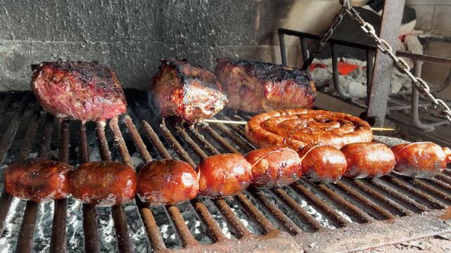 Close Up of Meat and Sausages on the Grill &ndash; Classic Argentine Asado Cooking Process - Argentina, Tradition, Barbecue