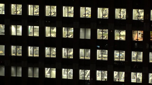 TOKYO, JAPAN : Close up shot of office building window at night. Job, work, company, corporate and business people concept time lapse video.