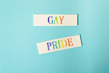 Fototapeta premium Gay Pride Text in Rainbow Colors on Blue Background