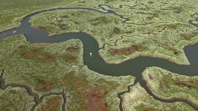 Boat on winding river in Blakeney National Nature Reserve, United Kingdom