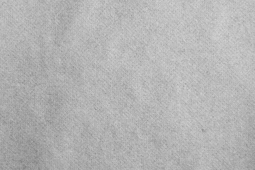 Full frame view of grey non-woven fabric material texture with fine porous pattern for industrial or textile background. © beautiful-photo.de