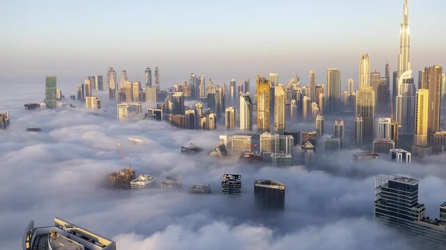 dubai with mist of clouds below the skyline from a high vantage point 