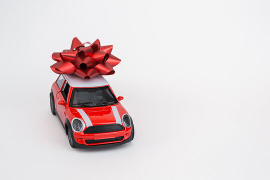 VINNITSA, UKRAINE - September 23, 2022: Red Toy Car with a Large Gift Bow on Top