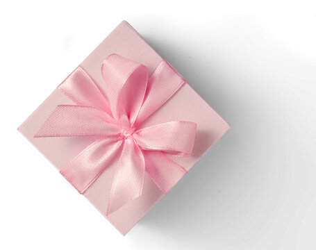Pink gift box with pale ribbon bow on white or transparent background