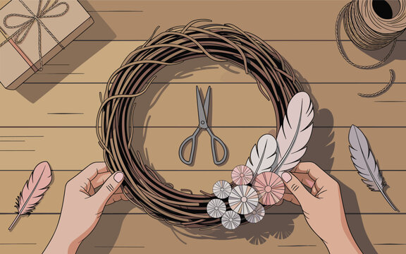 Hands crafting a floral wreath on a wooden table with scissors and feathers