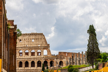 Fototapeta premium Famous tourist attraction of historic Colosseum amphitheatre with ancient stone arches in Rome Italy