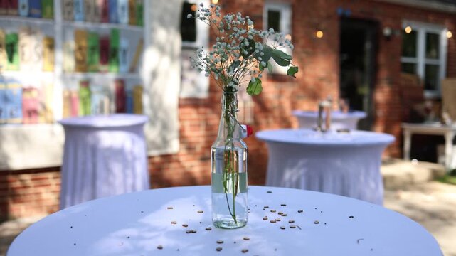 Glass vase centerpiece on outdoor event table