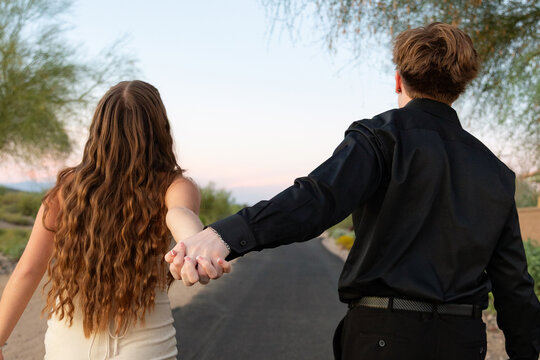 Young couple walking down desert path