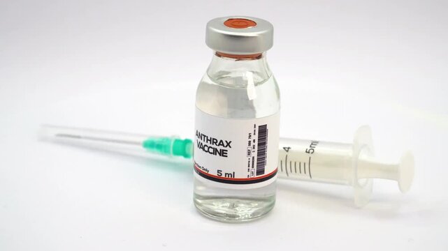 Anthrax vaccine development close up shot with scientific syringe inside medical biotechnology laboratory in 4K Ultra HD footage.
