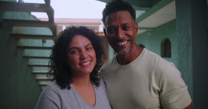 Close-up of cheerful African couple standing in a hallway, radiating love and unity, celebrating a moment of happiness and togetherness