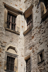 Fototapeta premium Historic stone walls have barred windows and weathered textures