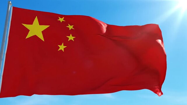 Vibrant Chinese flag waving proudly against a clear blue sky with bright sun.