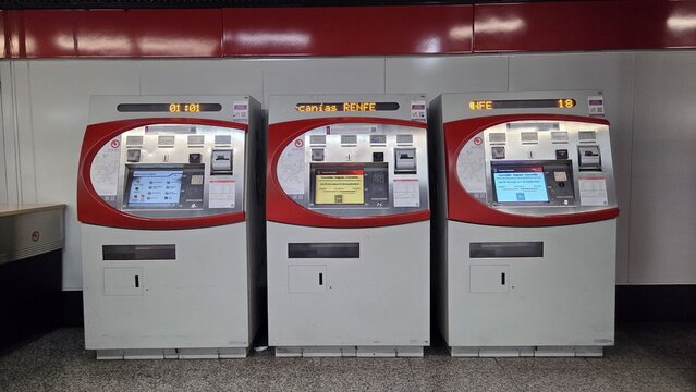 MADRID, SPAIN - JUNE, 22, 2026. Three automated ticket machines and touch kiosks at renfe station for fare purchase background and self service transport design