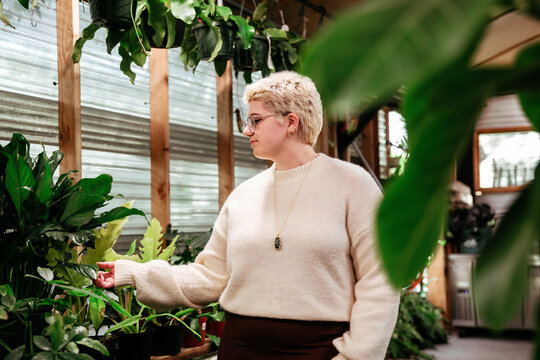 young woman surrounded by plants