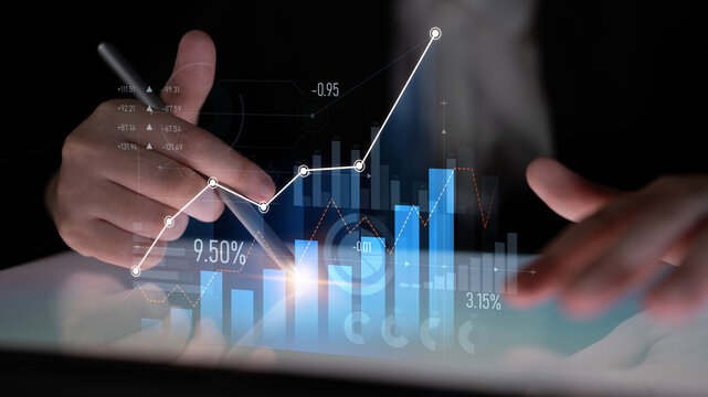 A businessman closely examines stock market data on a tablet, utilizing digital graphs and charts to make informed decisions. A modern approach to business analytics. Scalp