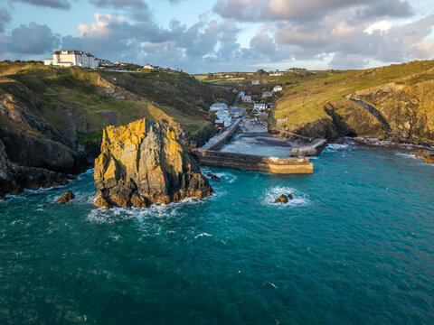 Aerial view from the sea of the Cornish fishing village of Mullion Cove and its historic harbour