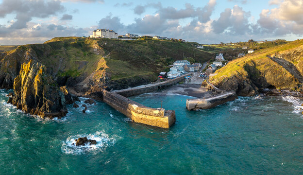 Aerial view from the sea of the Cornish fishing village of Mullion Cove and its historic harbour