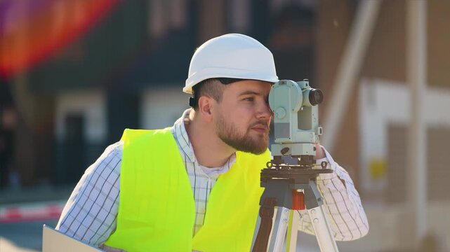 Surveyor engineer using theodolite measuring on construction site