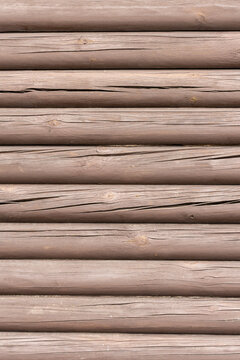 close up view of horizontal brown timber log stack to form a wall texture with copy space and no people.