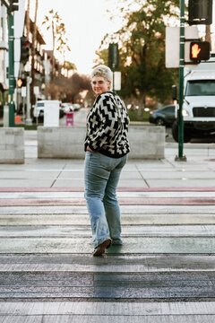 young woman crossing the street