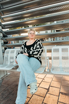 girl sitting and waiting for light rail at station platform 