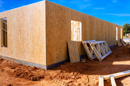 Workers build new beams structure using wooden trusses materials supplies at construction site