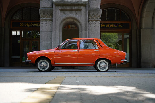 Side view profile of a classic orange Dacia 1300 vintage car, a licensed replica of the Renault 12, parked in Subotica, Serbia, on June 7, 2026