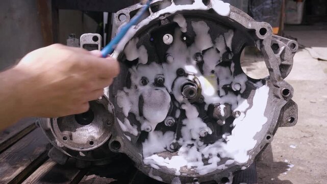 old gear shift box for front-wheel drive car cleaning from dirt with chemical agent and rinsing with water
