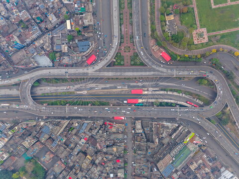 Aerial view of the Azadi Interchange in Lahore, featuring complex multi-level road networks, surrounding urban density, and the nearby Minar-e-Pakistan monument in Lahore, Punjab, Pakistan.