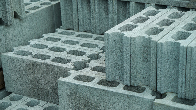 Stacked hollow concrete blocks at a construction yard
