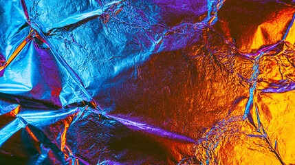 Naklejka premium Abstract crumpled metallic foil background with neon blue and copper lighting