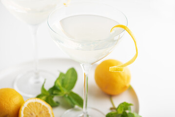 Fototapeta premium Citrus cocktail with lemon twist and fresh mint