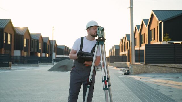 Surveyor engineer using theodolite level on construction site